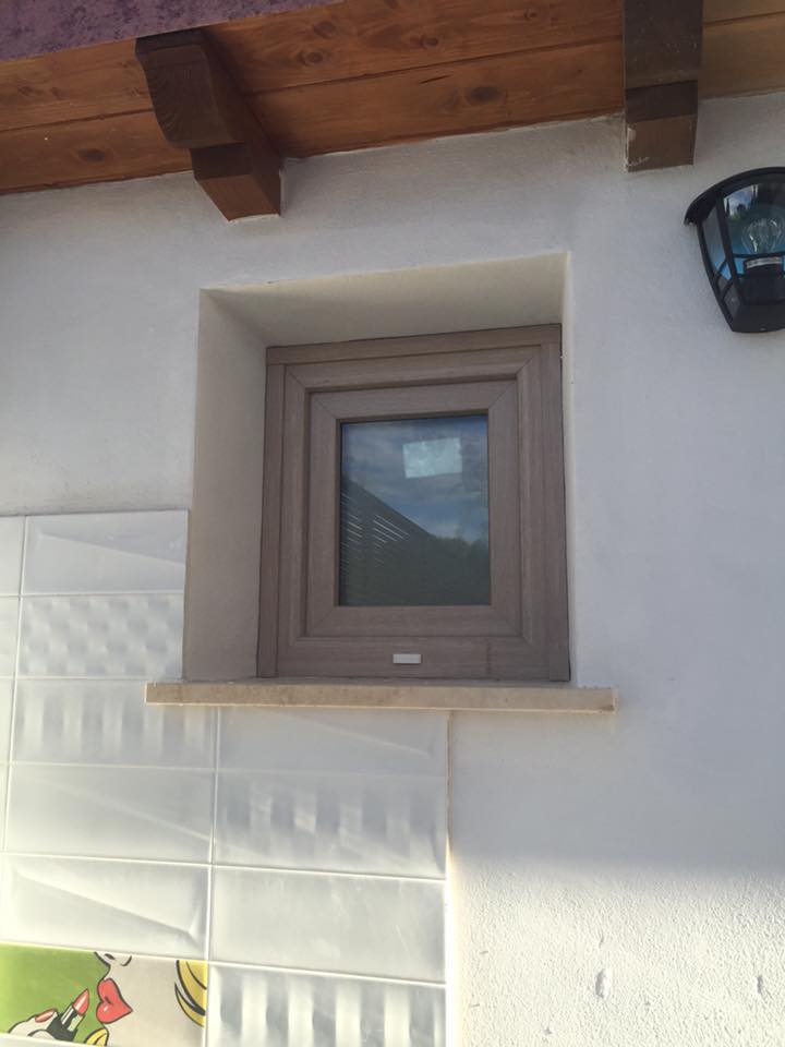 Piccola finestra effetto legno su facciata