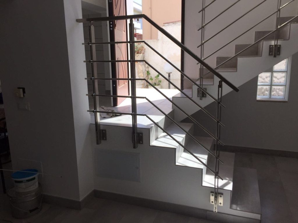 Ringhiera in acciaio su scala interna con vetrocemento