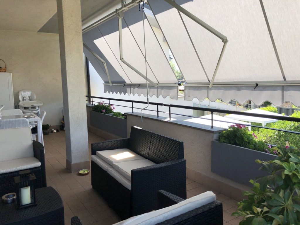 Terrazzo con ringhiera e tenda da sole